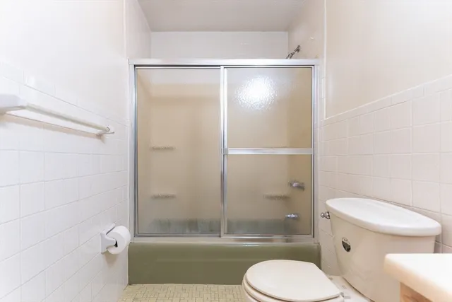 a bathroom with a toilet and a shower