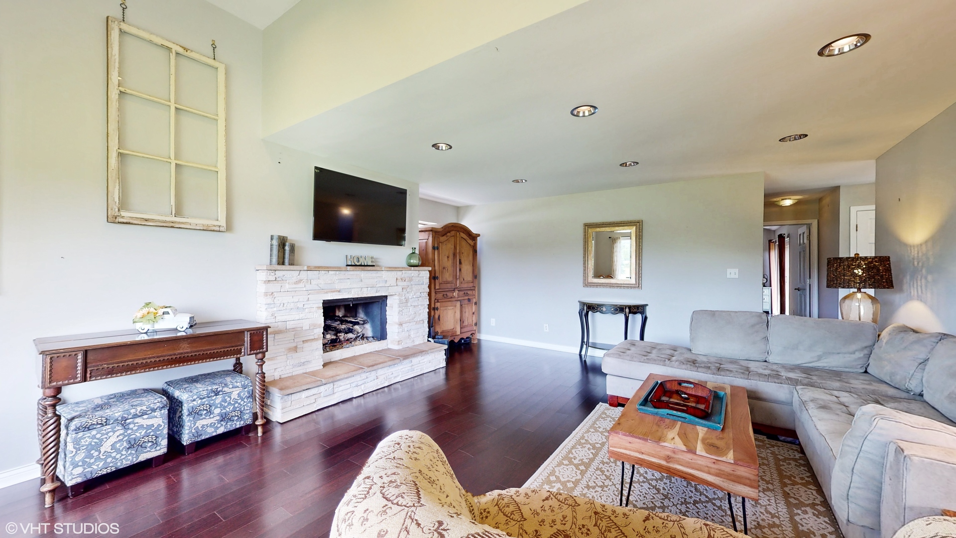 4213 White Ash Road Crystal Lake, IL 60014 - Photo 5 of 43 a living room with furniture a fireplace and a flat screen tv