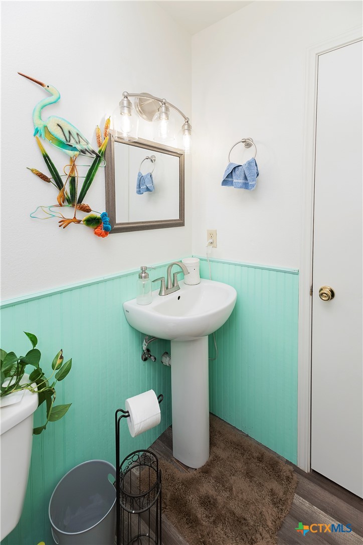 802 Bay Street Austwell, TX 77950 - Photo 13 of 27 a bathroom with a sink toilet and a mirror