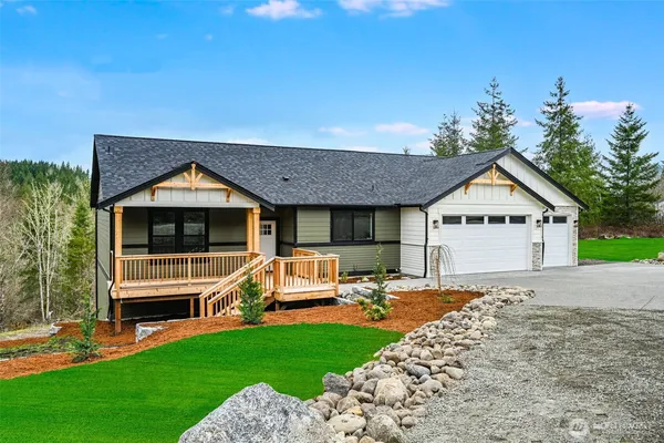 a front view of a house with a yard table and chairs
