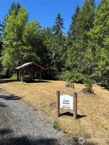 a sign board with a car park in the back