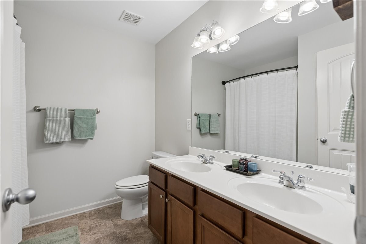 960 Morning Road Antioch, TN 37013 - Photo 26 of 36 a bathroom with a double vanity sink toilet and a mirror