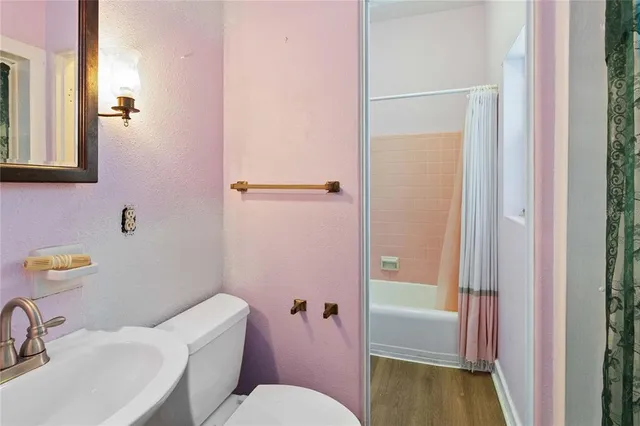 a bathroom with a sink a mirror and a toilet