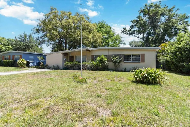 a view of house with yard and green space