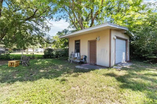 a view of a house with backyard sitting area and garden