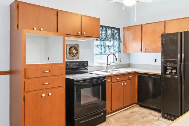 a kitchen with a refrigerator and a sink