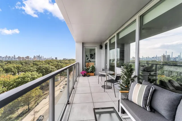 a balcony with furniture and a potted plant