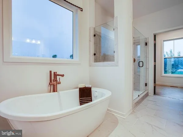 a bathroom with a bathtub and shower