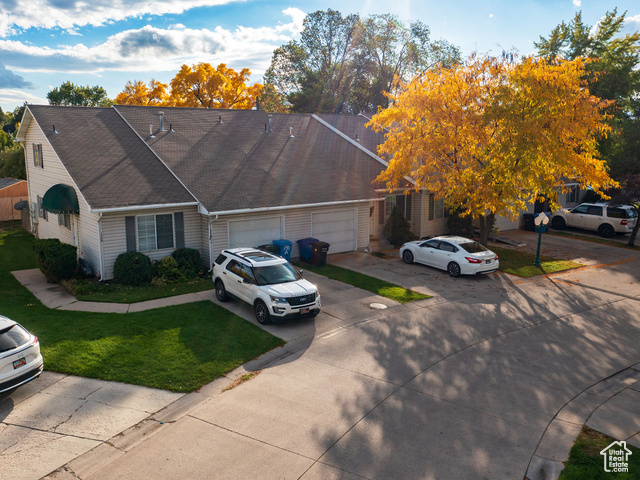 190 West 700 North Logan, UT 84321 - Photo 8 of 51 View of front facade with driveway, a front yard, roof with shingles, and an attached garage