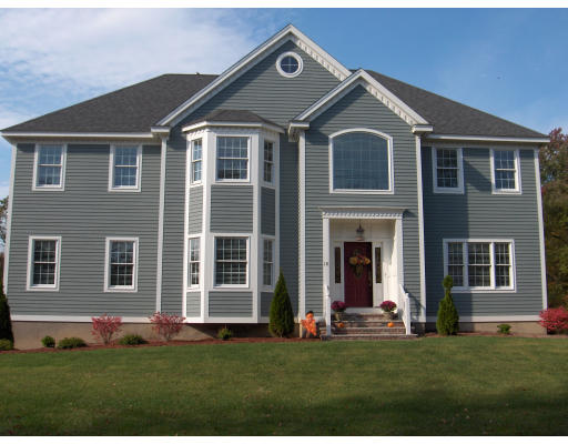 18 Symonds Way Reading, MA 01867 - Photo 1 of 26 a front view of a house with a yard