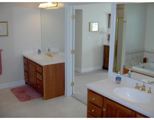 18 Symonds Way Reading, MA 01867 - Photo 11 of 26 a bathroom with a sink and a mirror