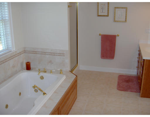 18 Symonds Way Reading, MA 01867 - Photo 12 of 26 a bathroom with a bathtub and a window