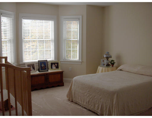 18 Symonds Way Reading, MA 01867 - Photo 14 of 26 a bedroom with a bed and wooden floor