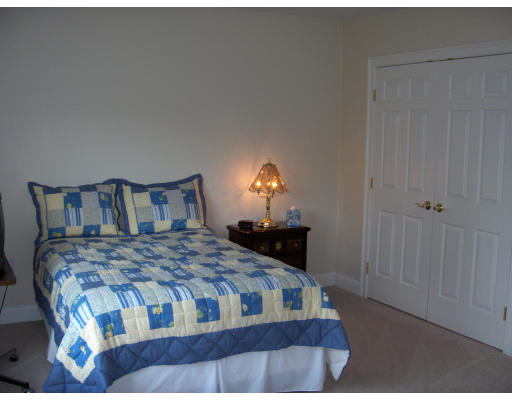 18 Symonds Way Reading, MA 01867 - Photo 15 of 26 a bedroom with a bed and a lamp