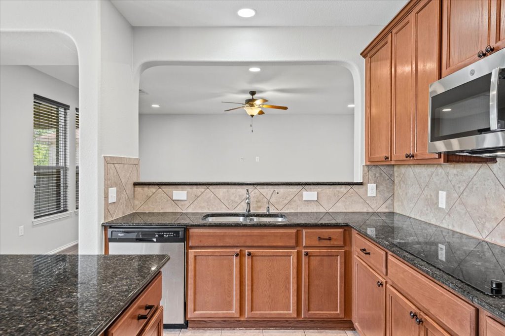 8804 Capitol View Drive Austin, TX 78747 - Photo 11 of 32 a kitchen with stainless steel appliances granite countertop a sink and a stove