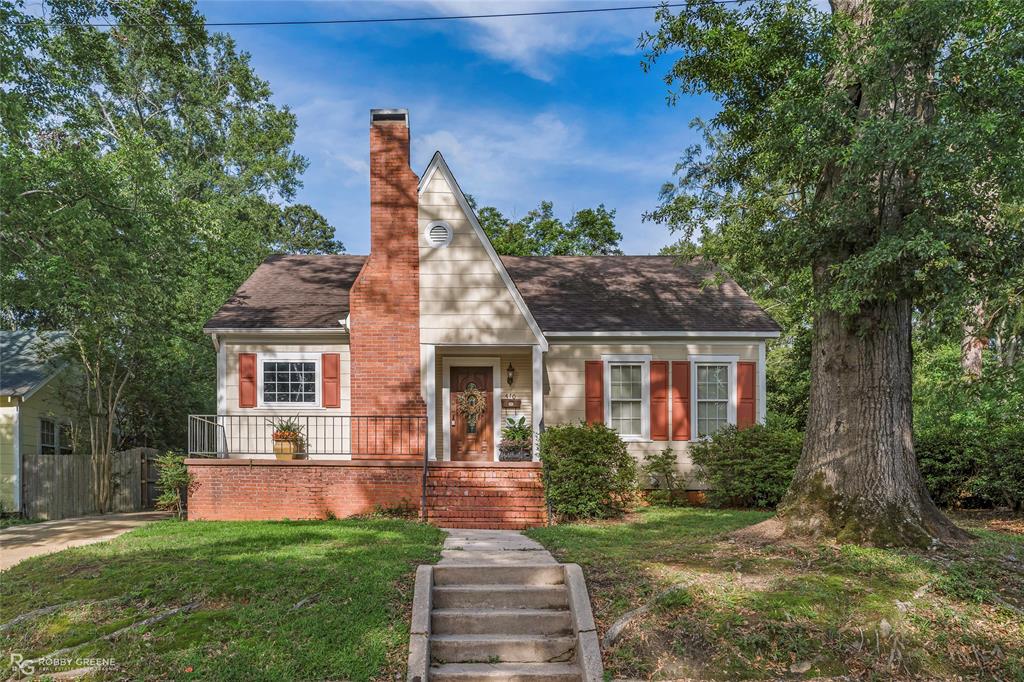 710 Buchanan Street Minden, LA 71055 - Photo 1 of 1 a front view of a house with a garden and yard