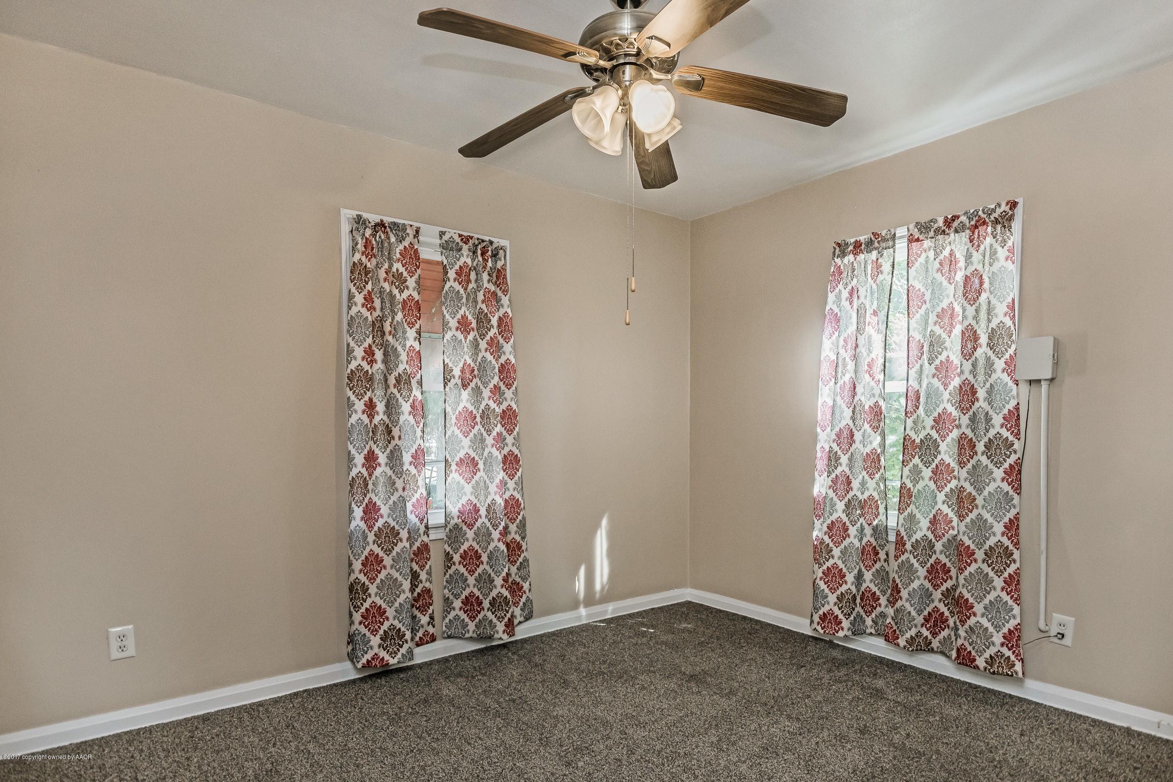 4119 South Hayden Street Amarillo, TX 79110 - Photo 10 of 15 a view of room with window and a ceiling fan