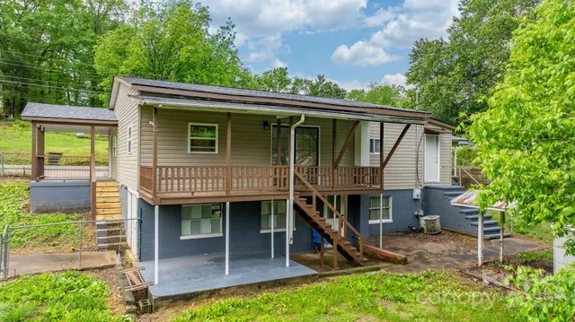 a view of a house with a roof deck and a garden