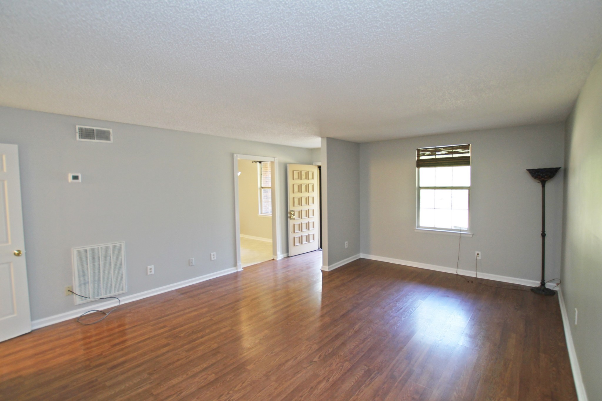 1301 Neelys Bend Road, Unit 91 Madison, TN 37115 - Photo 13 of 33 a view of an empty room with wooden floor and windows