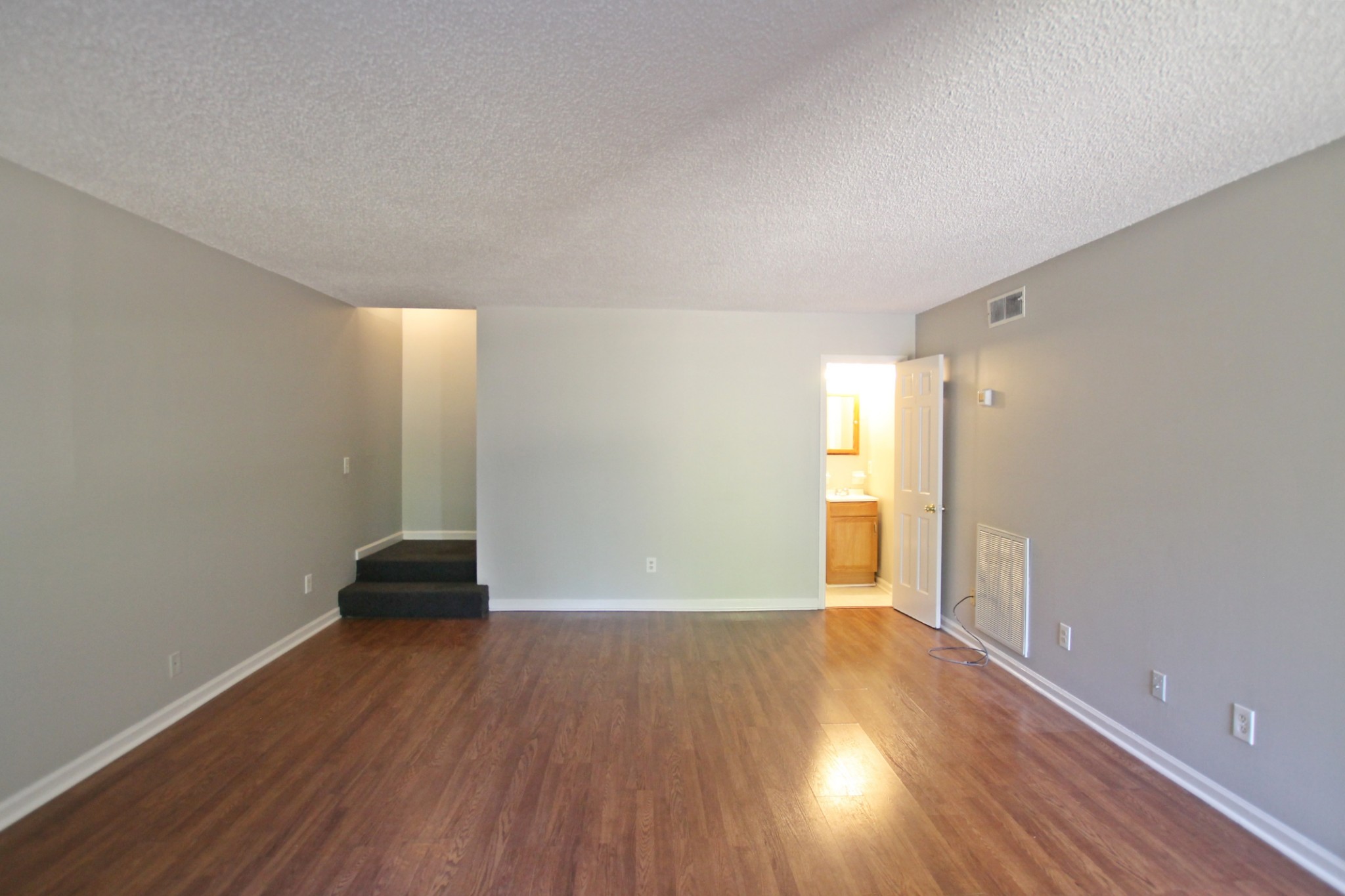 1301 Neelys Bend Road, Unit 91 Madison, TN 37115 - Photo 14 of 33 an empty room with wooden floor and windows