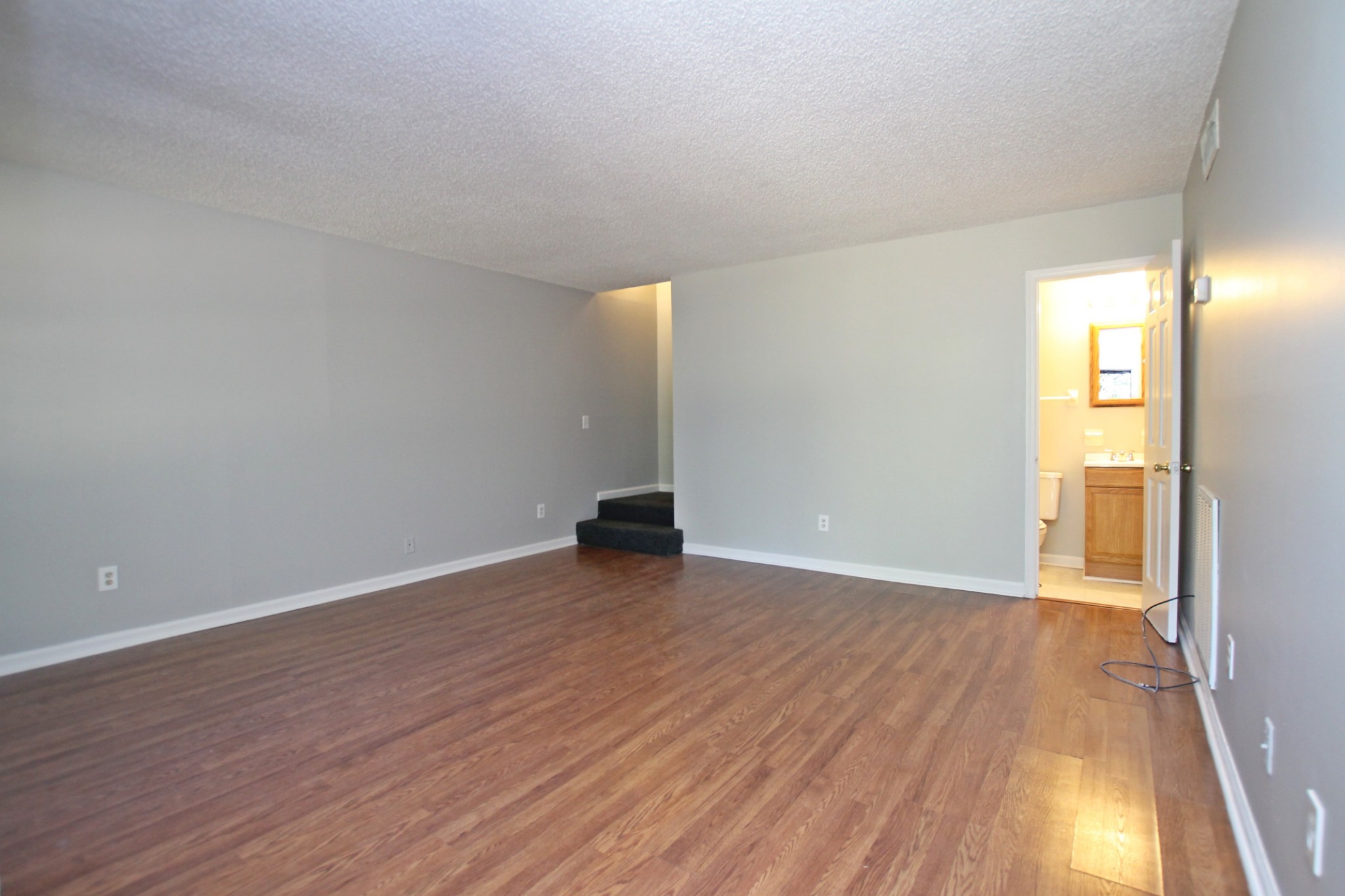 1301 Neelys Bend Road, Unit 91 Madison, TN 37115 - Photo 17 of 33 a view of an empty room with wooden floor and a window