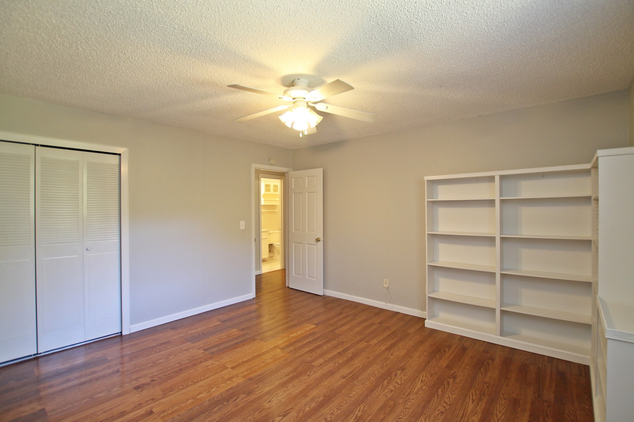 1301 Neelys Bend Road, Unit 91 Madison, TN 37115 - Photo 20 of 33 a view of an empty room with a window and wooden floor