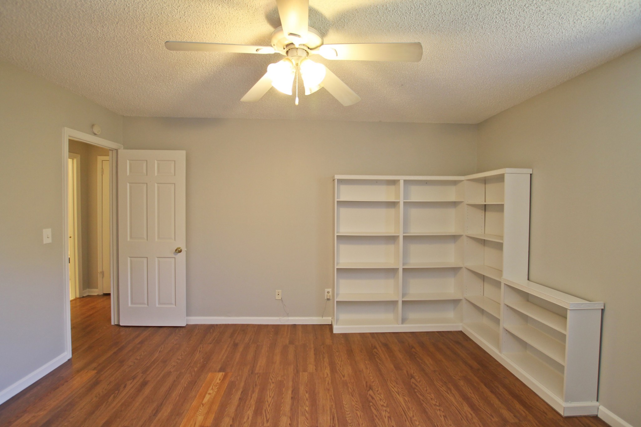 1301 Neelys Bend Road, Unit 91 Madison, TN 37115 - Photo 23 of 33 a view of a room with wooden floor and a ceiling fan