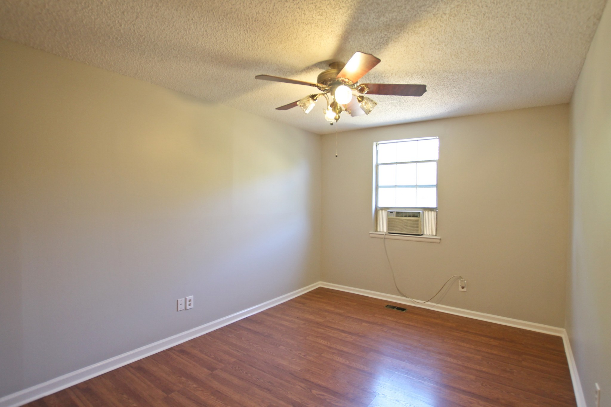 1301 Neelys Bend Road, Unit 91 Madison, TN 37115 - Photo 25 of 33 a view of an empty room with wooden floor and a window