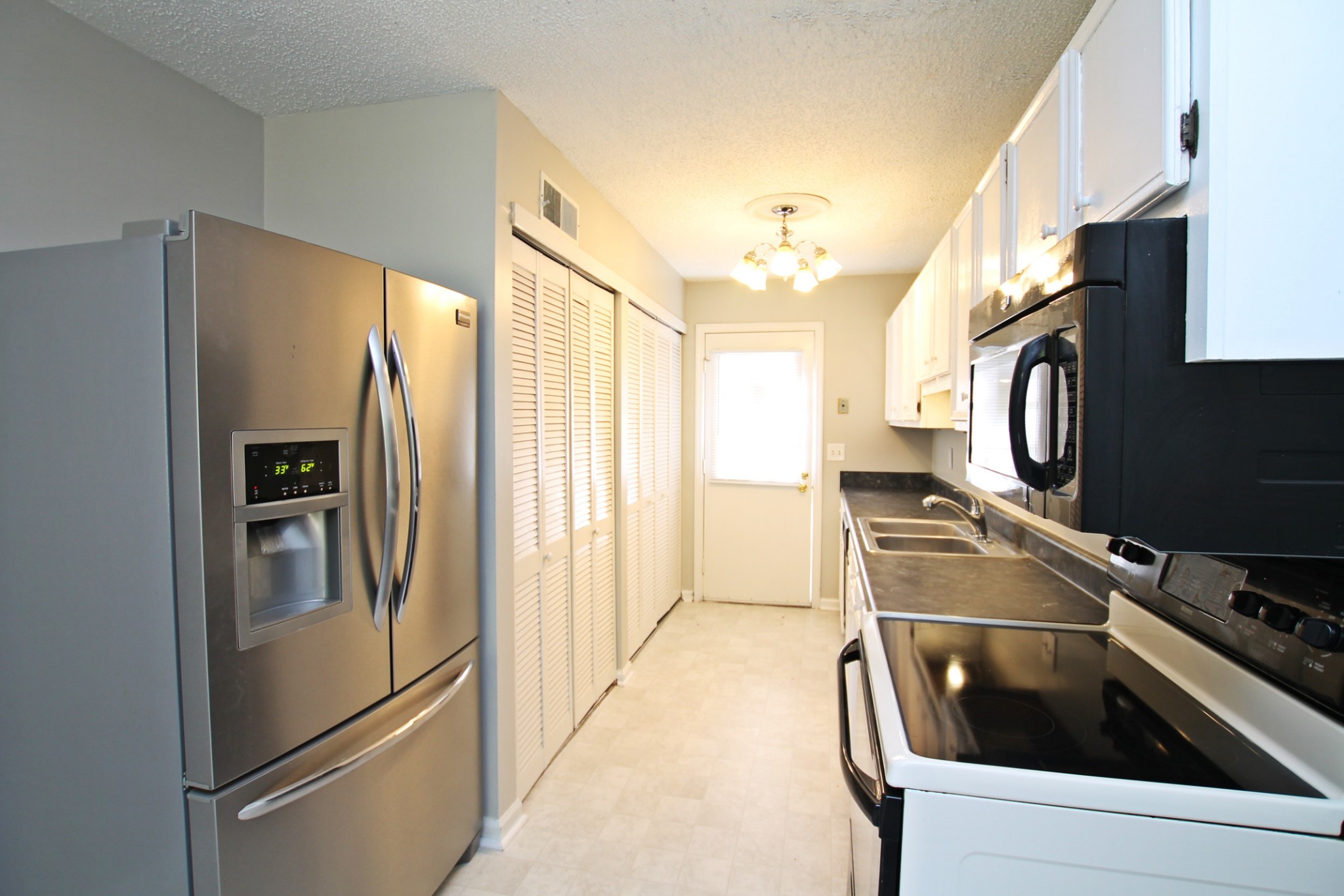 1301 Neelys Bend Road, Unit 91 Madison, TN 37115 - Photo 6 of 33 a kitchen with stainless steel appliances granite countertop a refrigerator and a stove