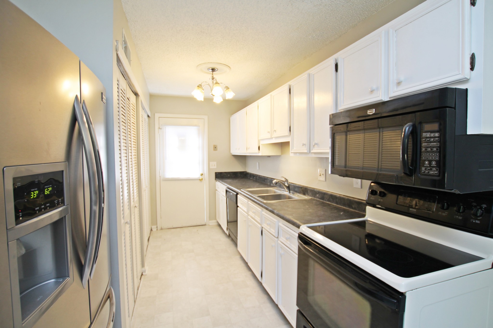1301 Neelys Bend Road, Unit 91 Madison, TN 37115 - Photo 7 of 33 a kitchen with stainless steel appliances granite countertop a stove a sink and a microwave
