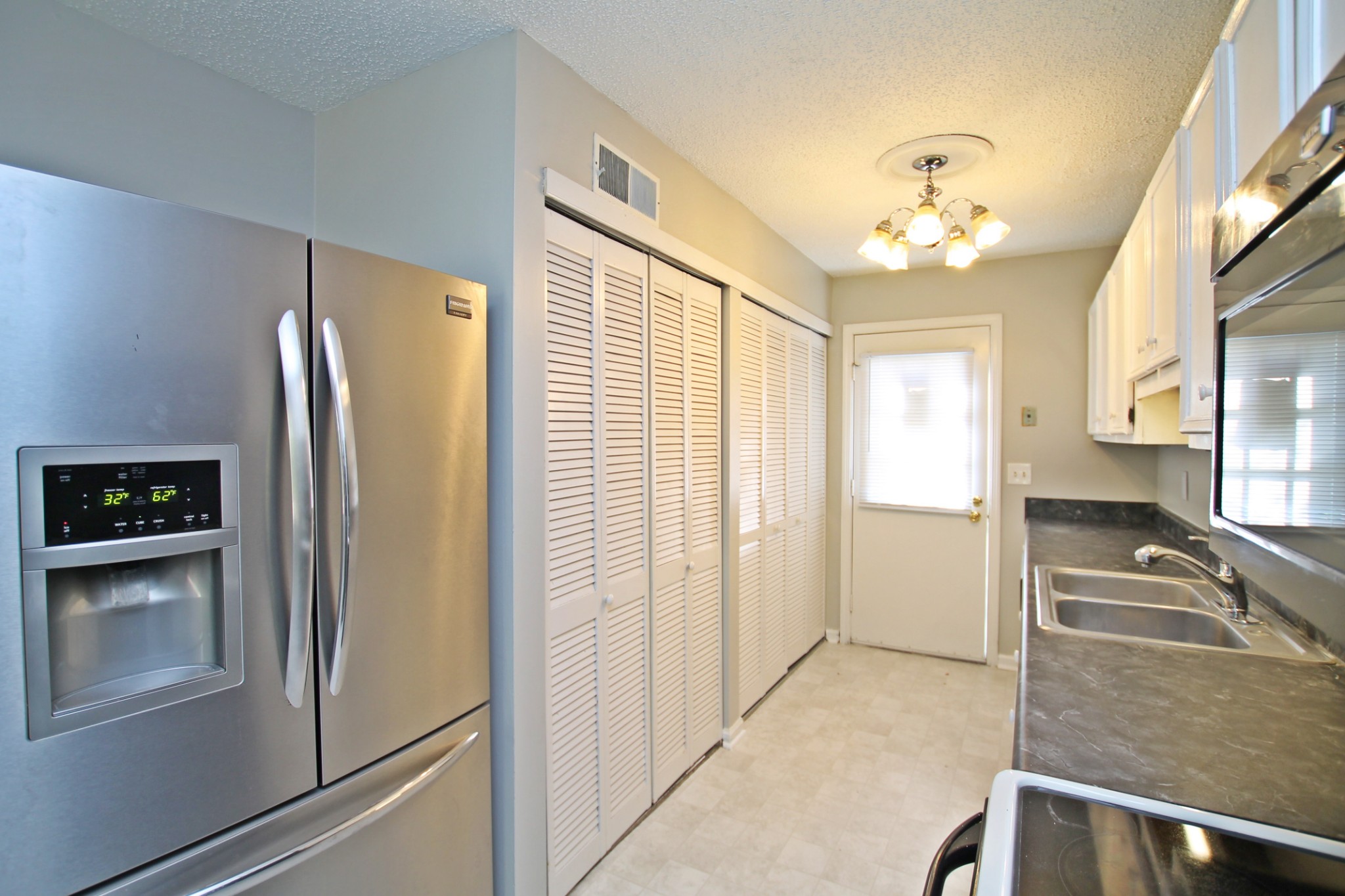 1301 Neelys Bend Road, Unit 91 Madison, TN 37115 - Photo 9 of 33 a view of a kitchen with a refrigerator a sink dishwasher and a refrigerator