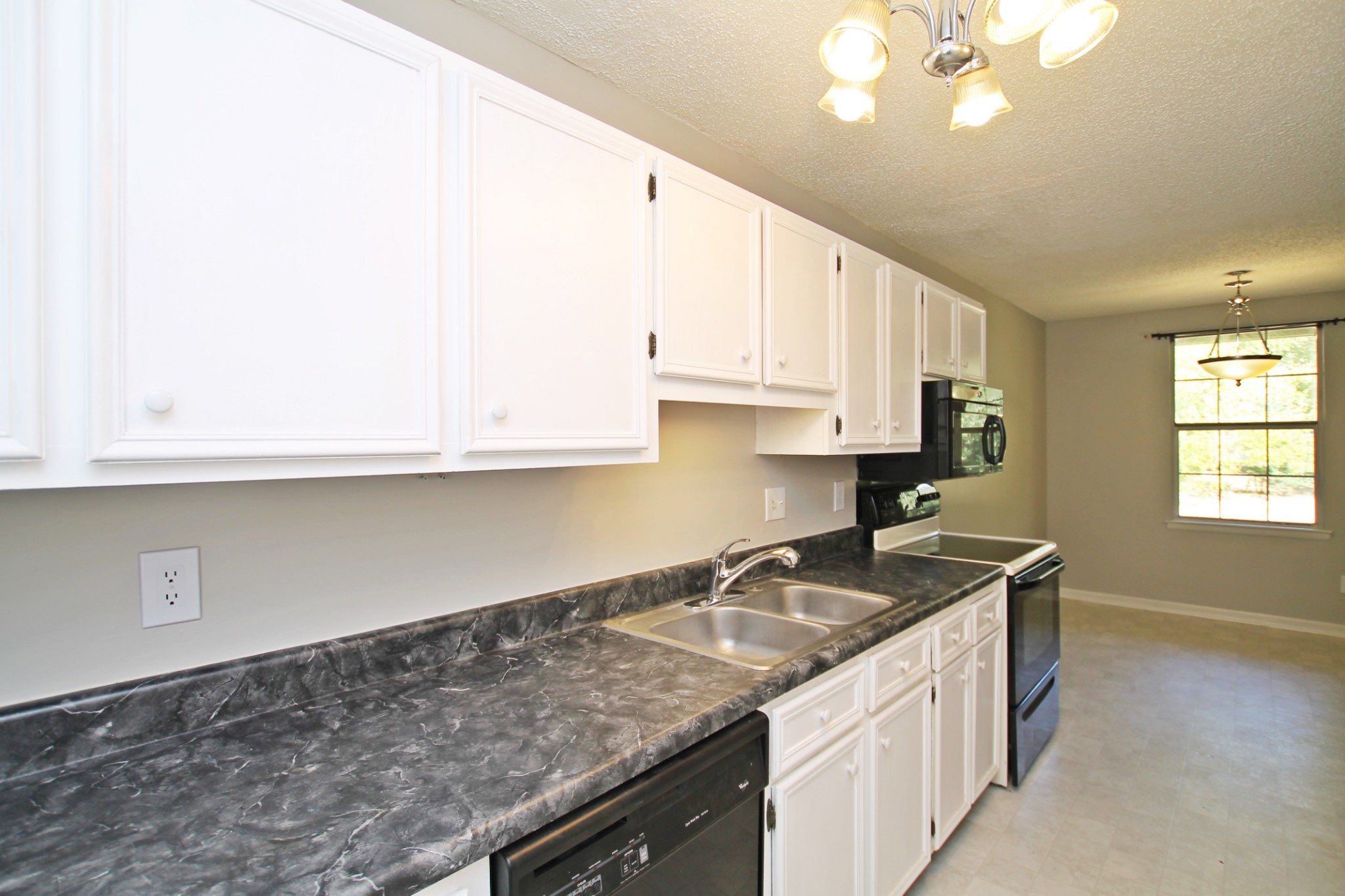 1301 Neelys Bend Road, Unit 91 Madison, TN 37115 - Photo 10 of 33 a kitchen with granite countertop a sink a stove and cabinets