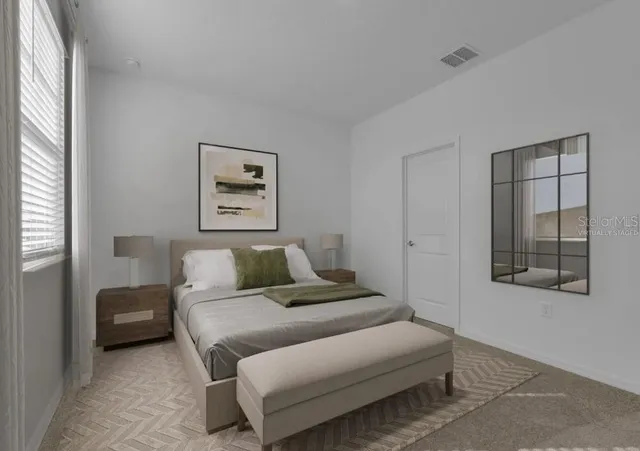 a bedroom with a bed and a painting on the wall