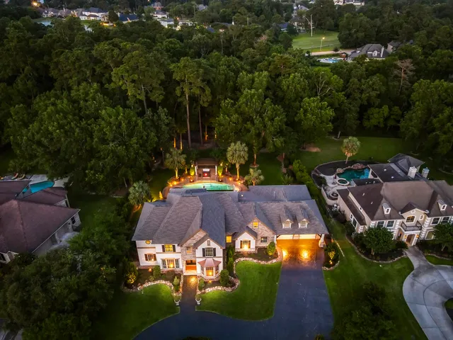 an aerial view of a house with yard swimming pool and outdoor seating