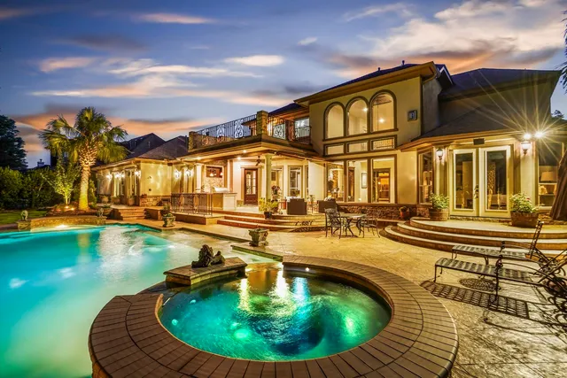 a view of a swimming pool with outdoor seating