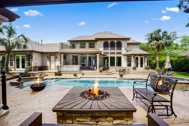 a view of a house with swimming pool and sitting area
