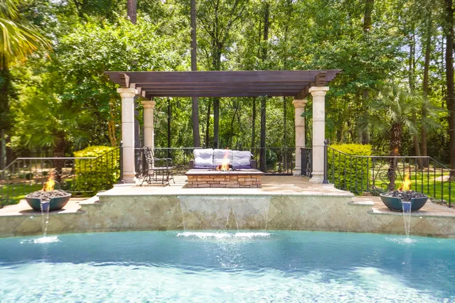 a view of a backyard with a garden and sitting area
