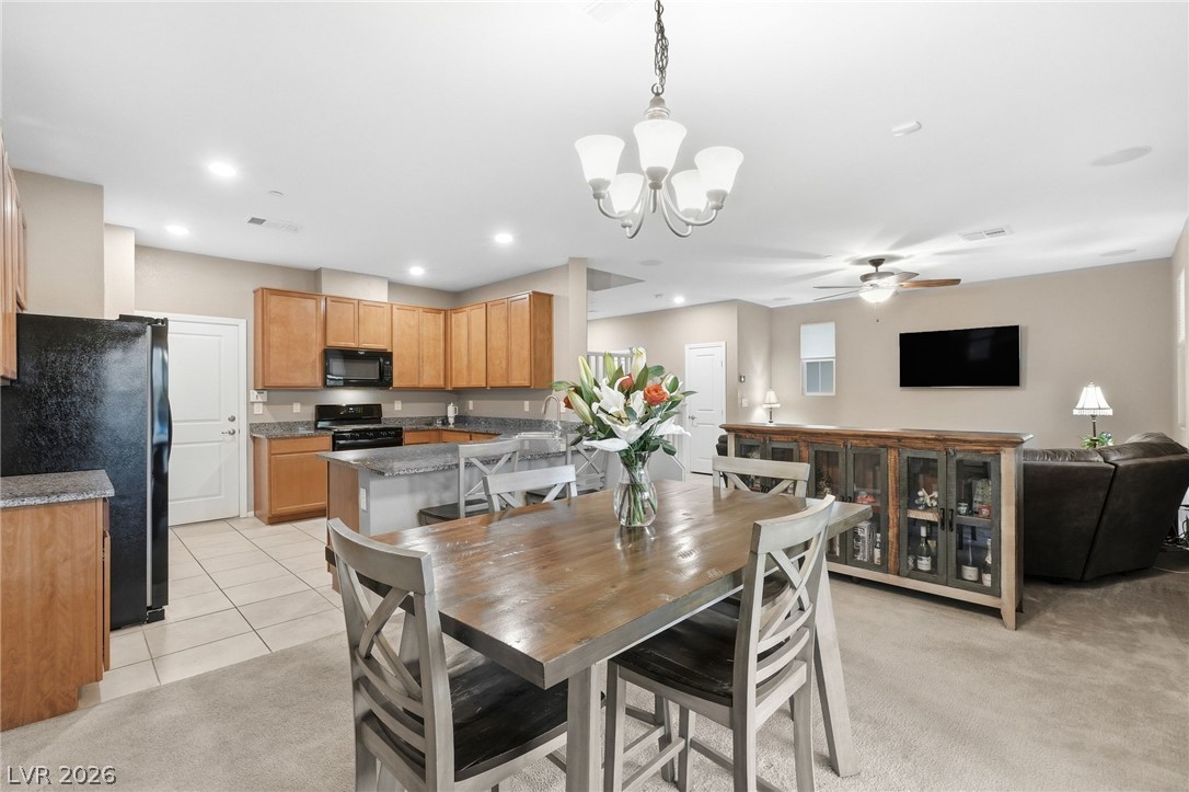 150 Fulgora Street Henderson, NV 89074 - Photo 30 of 92 Dining area featuring suspended lighting, ceiling fan, light tile patterned floors, and light colored carpet