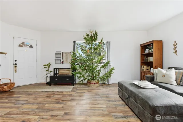 a living room with furniture and a potted plant