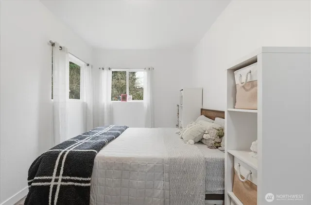 a bedroom with a bed and window