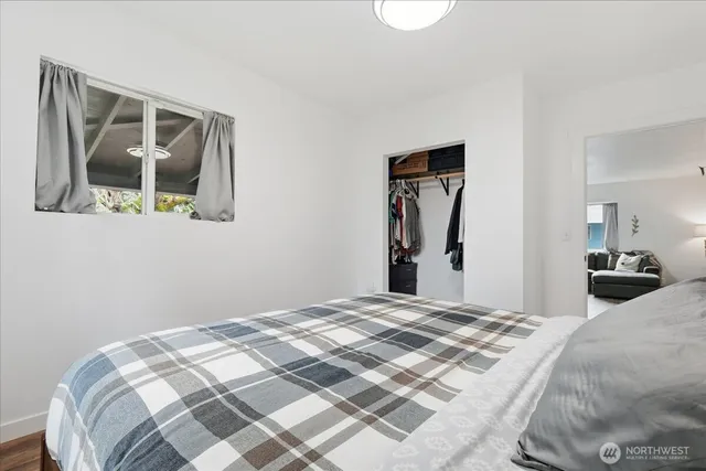 a bedroom with a bed and a mirror