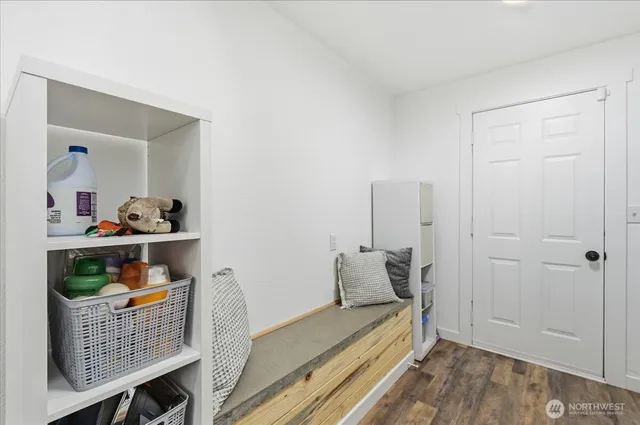 a bedroom with furniture and wooden floor