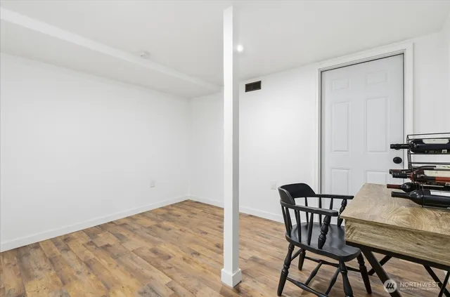 a view of room with furniture and wooden floor