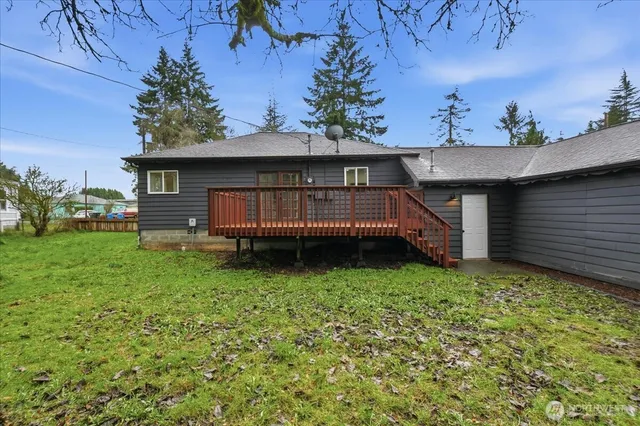 a view of backyard with a garden and deck