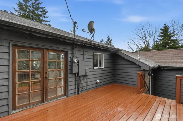 a backyard of a house with wooden floor and outdoor seating