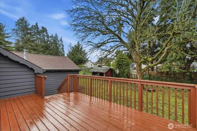 a view of backyard with a deck and wooden floor