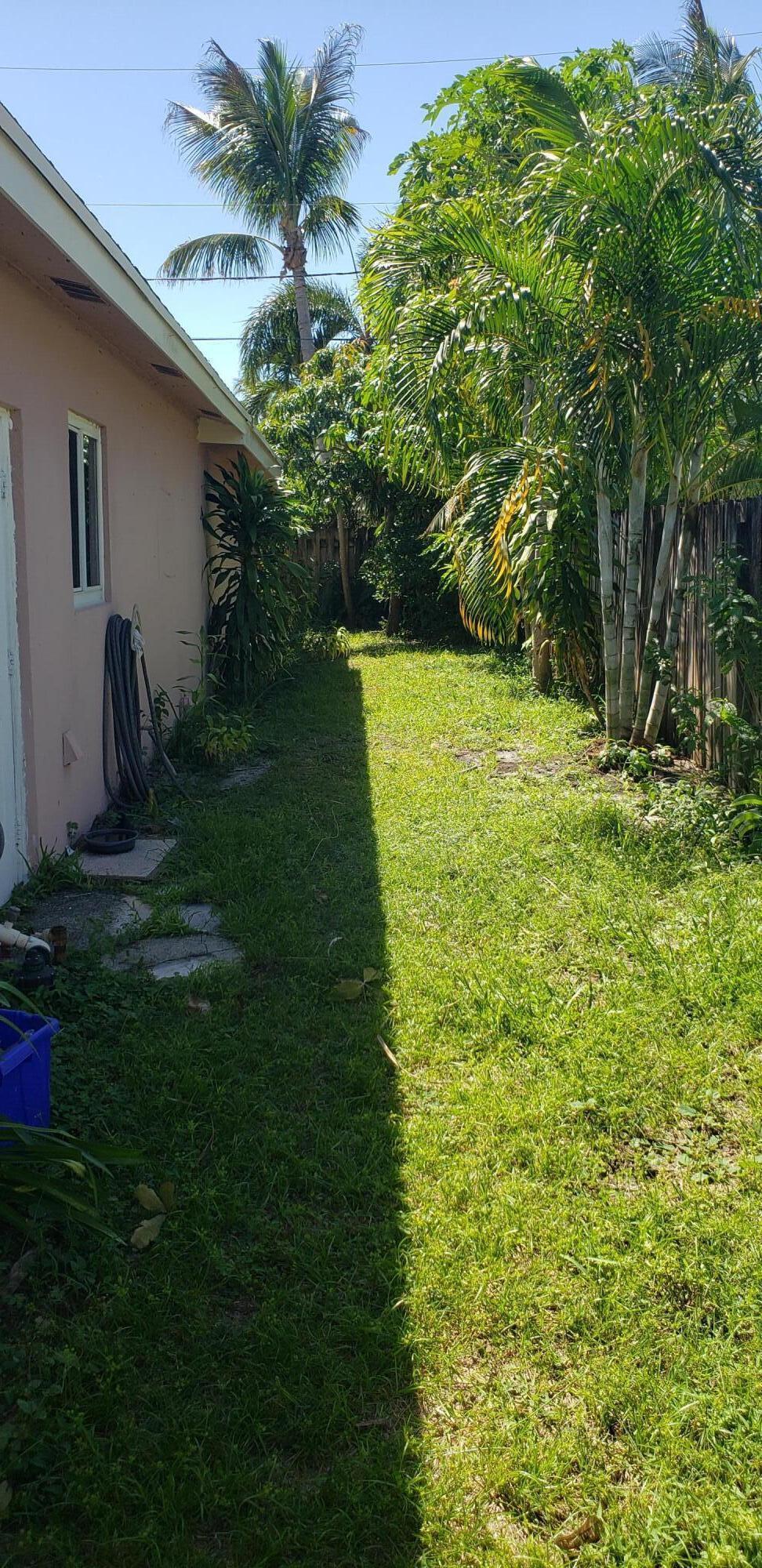 98 Seminole Lane Boca Raton, FL 33487 - Photo 26 of 42 a view of a house with a backyard
