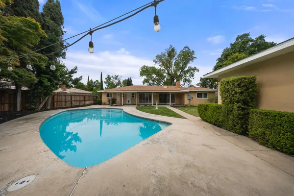 a view of a swimming pool with a patio