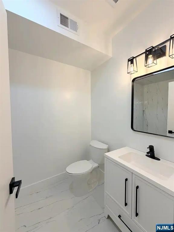 39 South 7th Street, Unit 2 3 Newark, NJ 07107 - Photo 11 of 13 a view of bathroom with a toilet sink and mirror