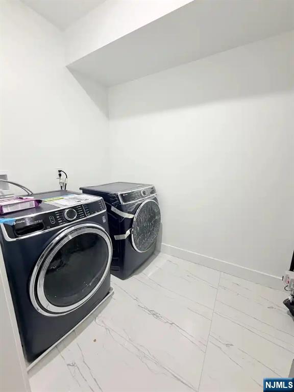 39 South 7th Street, Unit 2 3 Newark, NJ 07107 - Photo 13 of 13 a utility room with dryer and washer